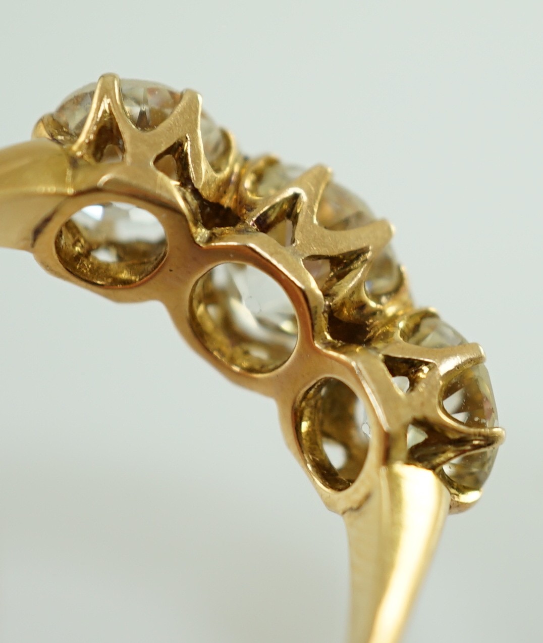 A gold and three stone diamond ring